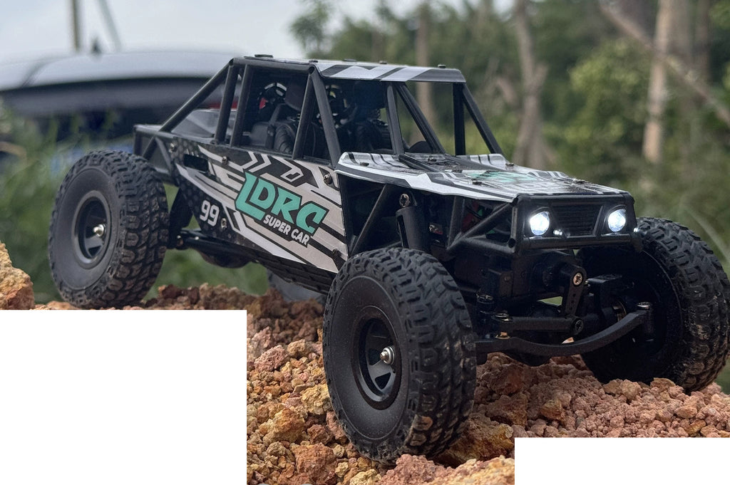 Blue LD18499 crawler with 99 side graphics on rocky ground