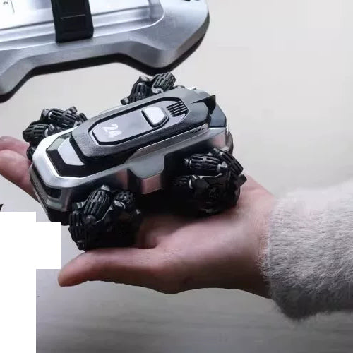 Silver RC stunt car marked 24 held in a hand