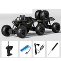 Black RC crawler and its pictured controller and charging accessories.