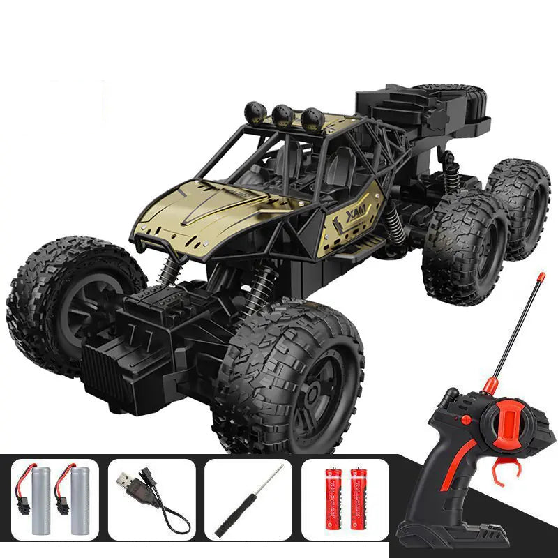 Gold RC crawler and its pictured controller and charging accessories.