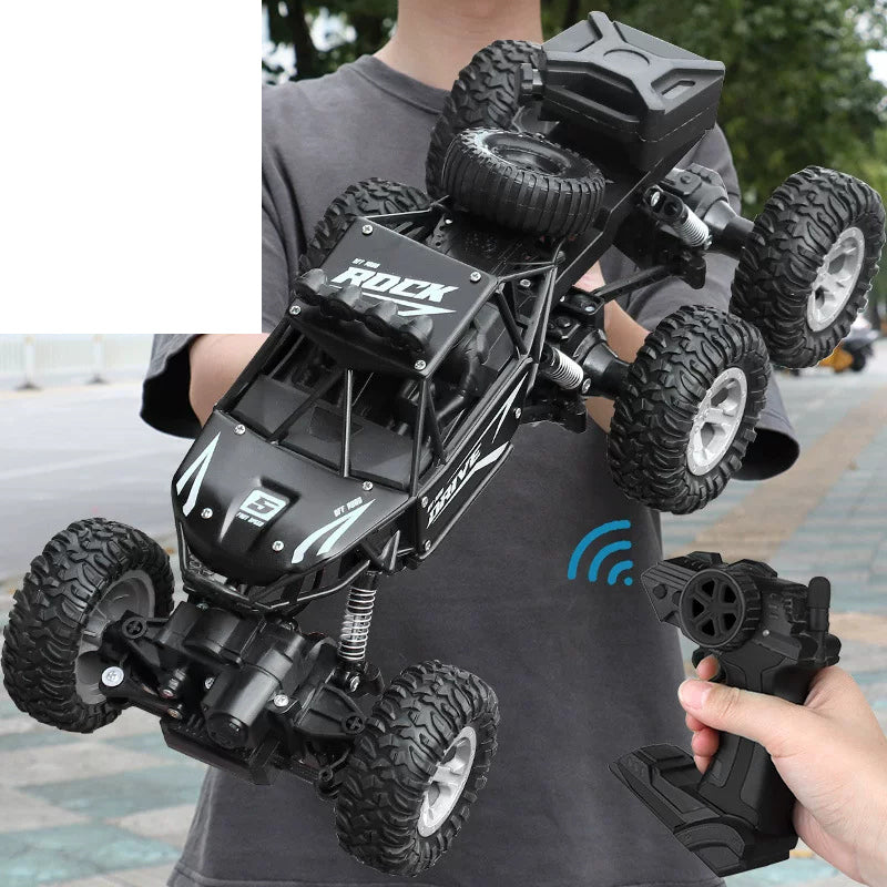 FIReX Six-Wheel RC Crawler - Version Selection: Black FIReX six-wheel crawler with standard rear box shown in hand