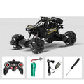 Black RC crawler and its pictured controller and charging accessories.