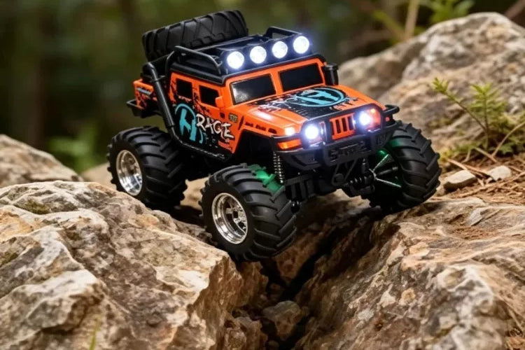 Reverse-side view of the orange RC truck on rocks
