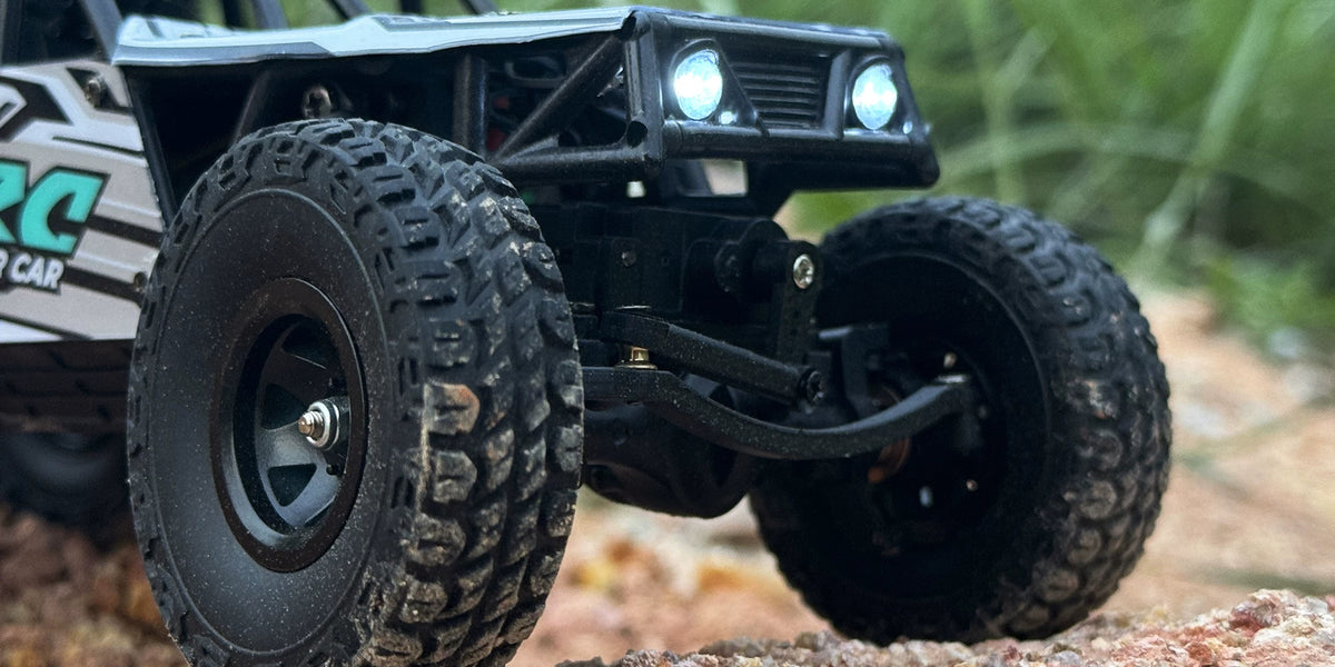 Front axle and tires of the blue LD18499 RC crawler
