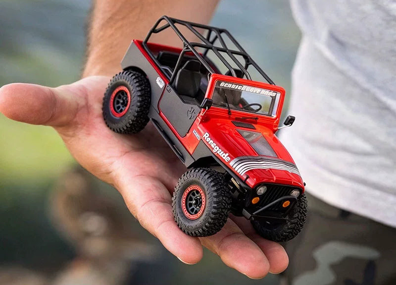 Red SCX30 Jeep CJ-7 in a hand for scale; hand is not included