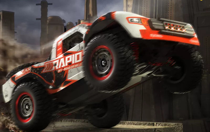 Orange RAPID Q130B from the opposite side with wheels raised on an obstacle