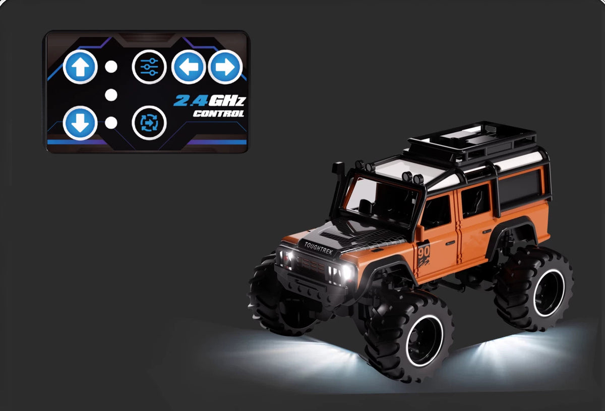 Orange Defender-style RC SUV beside its mini card remote