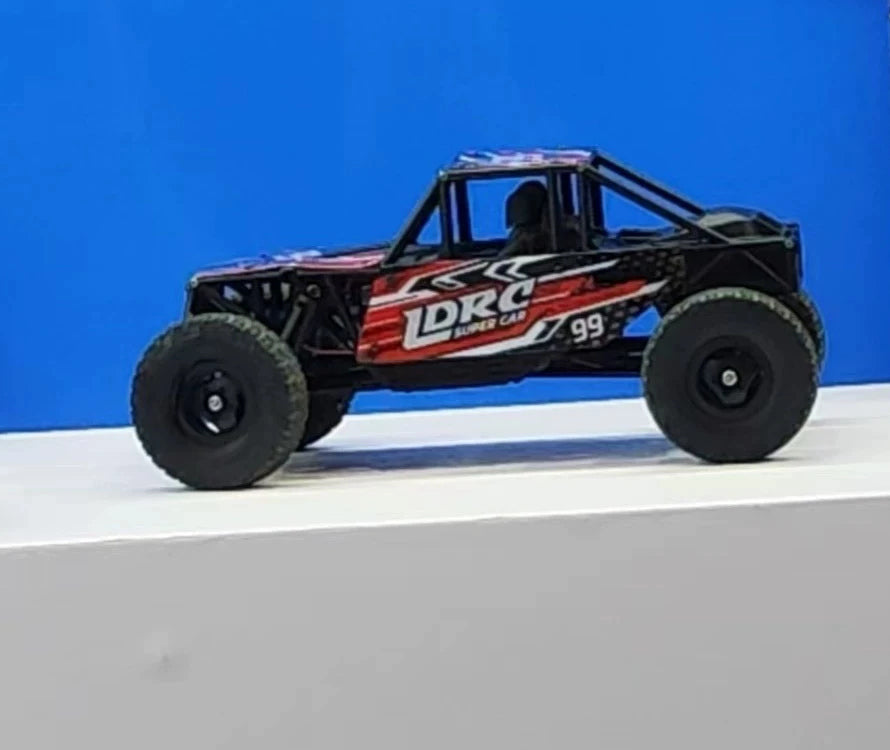 Red LD18499 tube-frame RC crawler in side profile