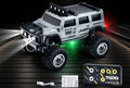 Silver Hummer-style mini RC SUV beside a card-style remote and USB cable