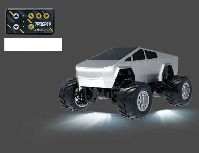 Silver smooth-cab RC monster pickup with chrome-finish wheel hubs and yellow-button card remote