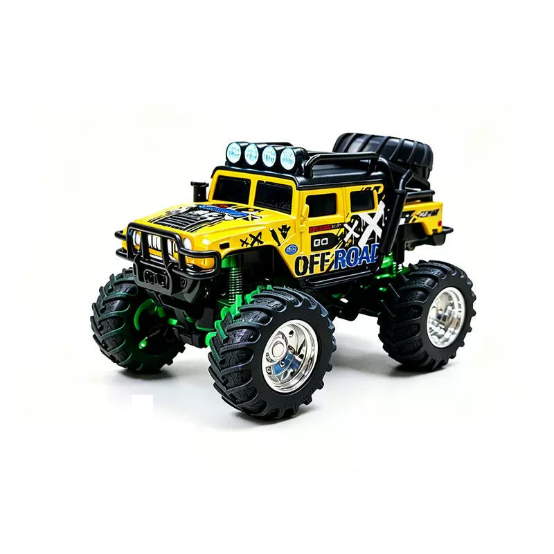Yellow mini RAGE RC truck showing its body graphics and treaded tires